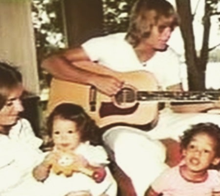 Anna during her childhood with her father, mother, and brother